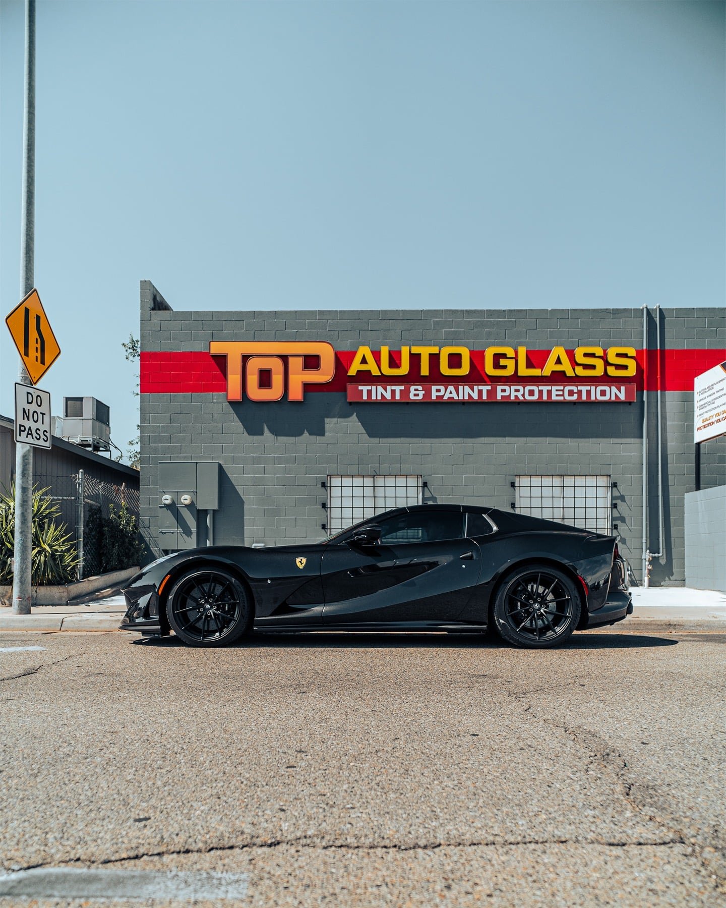 Top Auto Glass storefront on Barstow Ave in Clovis with a black Ferrari parked out front